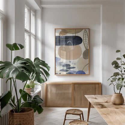 Leaves and Stones IV by Laura Horn. shown as a print in a natural wood frame in a dining room. Available as a archival giclee rolled canvas, fine art paper, or poster print. SKU 78486h.