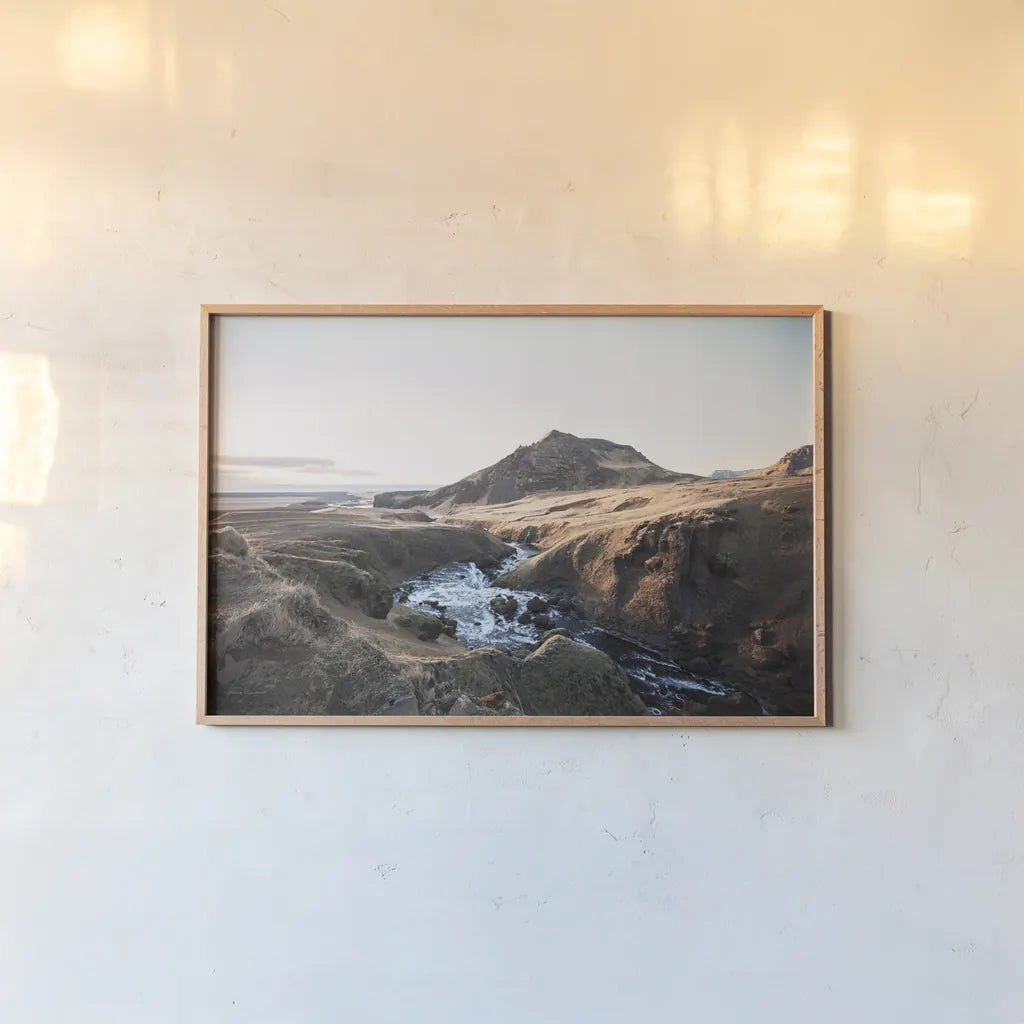Above Skogafoss by Laura Marshall. shown as a paper print in a natural frame. Available as a archival giclee rolled canvas, fine art paper, or poster print. SKU 69903i.