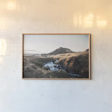 Above Skogafoss by Laura Marshall. shown as a paper print in a natural frame. Available as a archival giclee rolled canvas, fine art paper, or poster print. SKU 69903i.