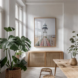 Brant Point Lighthouse by Laura Marshall. shown as a print in a natural wood frame in a dining room. Available as a archival giclee rolled canvas, fine art paper, or poster print. SKU 39641h.
