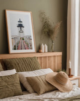 Brant Point Lighthouse by Laura Marshall. shown as a paper print in a natural frame. Available as a archival giclee rolled canvas, fine art paper, or poster print. SKU 39641h.