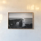 Dyrholaey by Laura Marshall. shown as a paper print in a natural frame. Available as a archival giclee rolled canvas, fine art paper, or poster print. SKU 64398i.