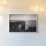 Dyrholaey by Laura Marshall. shown as a paper print in a white frame. Available as a archival giclee rolled canvas, fine art paper, or poster print. SKU 64398i.
