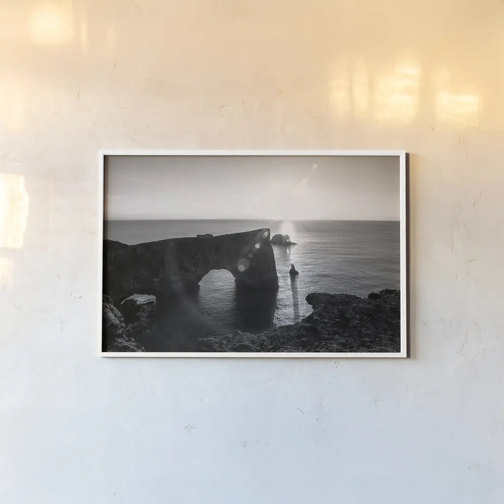 Dyrholaey by Laura Marshall. shown as a paper print in a white frame. Available as a archival giclee rolled canvas, fine art paper, or poster print. SKU 64398i.