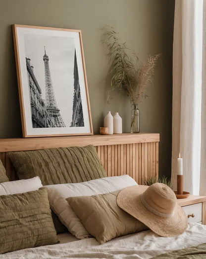 Eiffel Glimpse by Laura Marshall. shown as a paper print in a natural frame. Available as a archival giclee rolled canvas, fine art paper, or poster print. SKU 25887h.