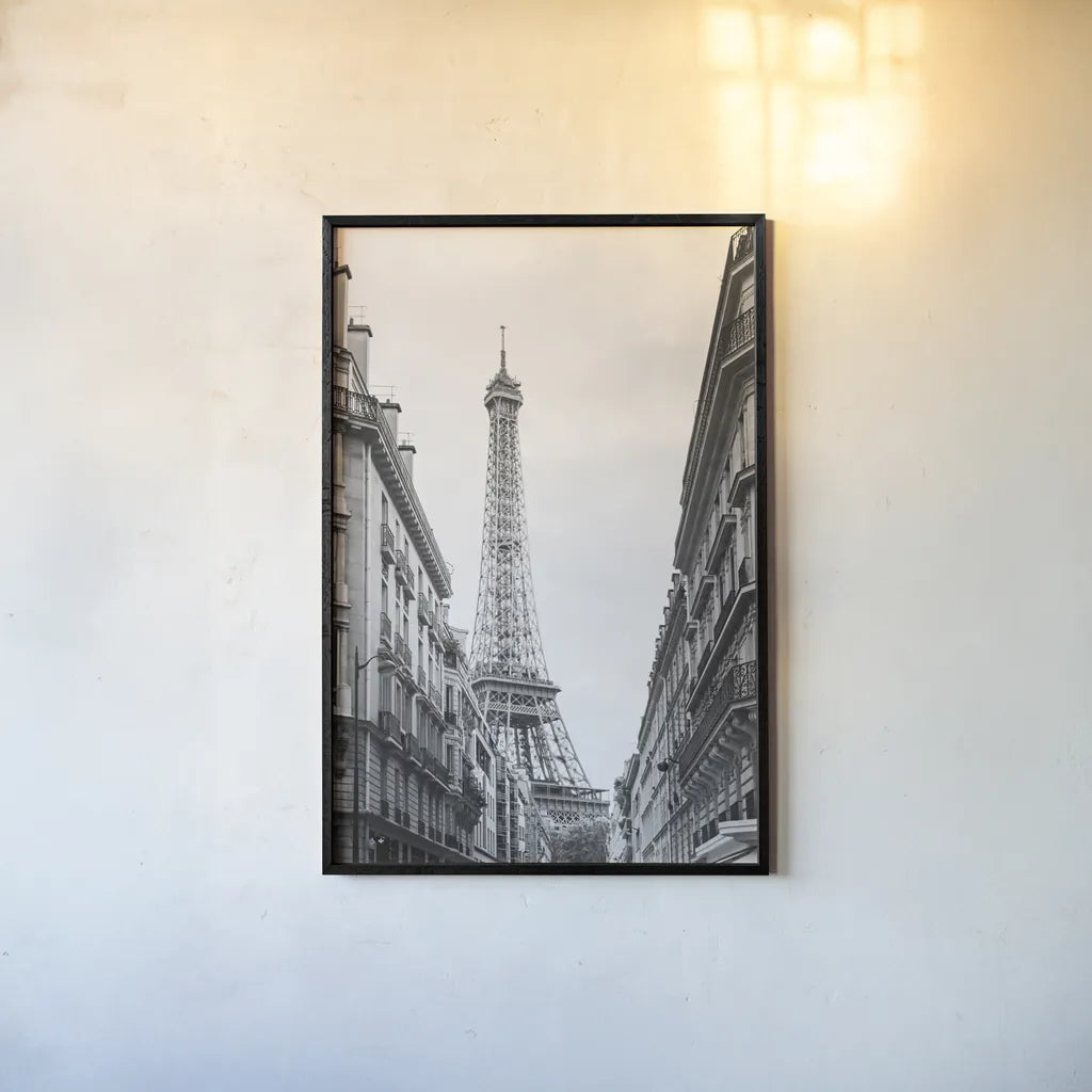 Eiffel Glimpse by Laura Marshall. shown as a paper print in a black flame. Available as a archival giclee rolled canvas, fine art paper, or poster print. SKU 25887h.