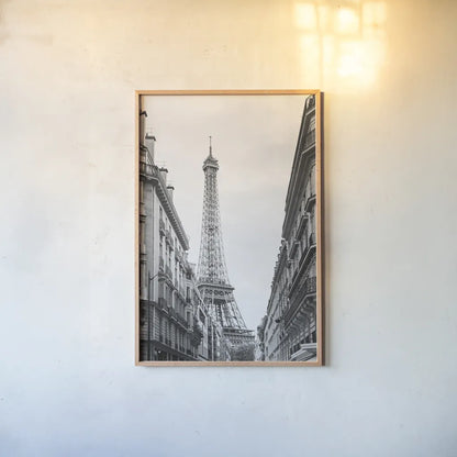 Eiffel Glimpse by Laura Marshall. shown as a paper print in a natural frame. Available as a archival giclee rolled canvas, fine art paper, or poster print. SKU 25887h.
