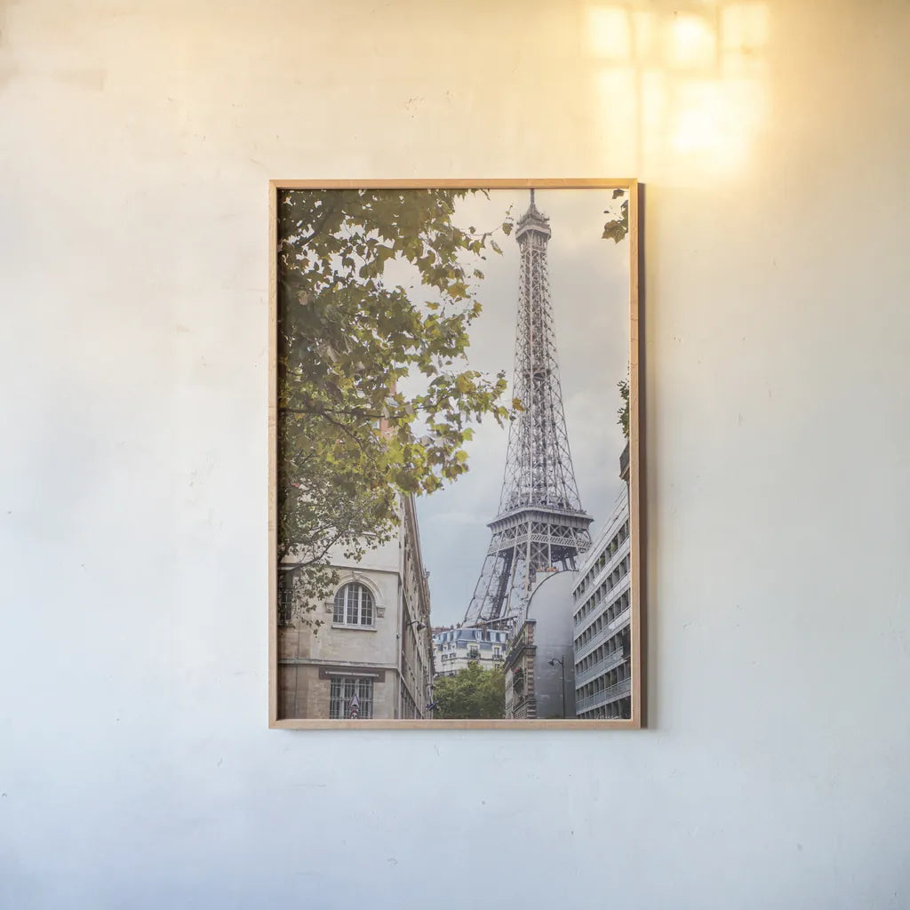 Eiffel View II by Laura Marshall. shown as a paper print in a natural frame. Available as a archival giclee rolled canvas, fine art paper, or poster print. SKU 30543h.