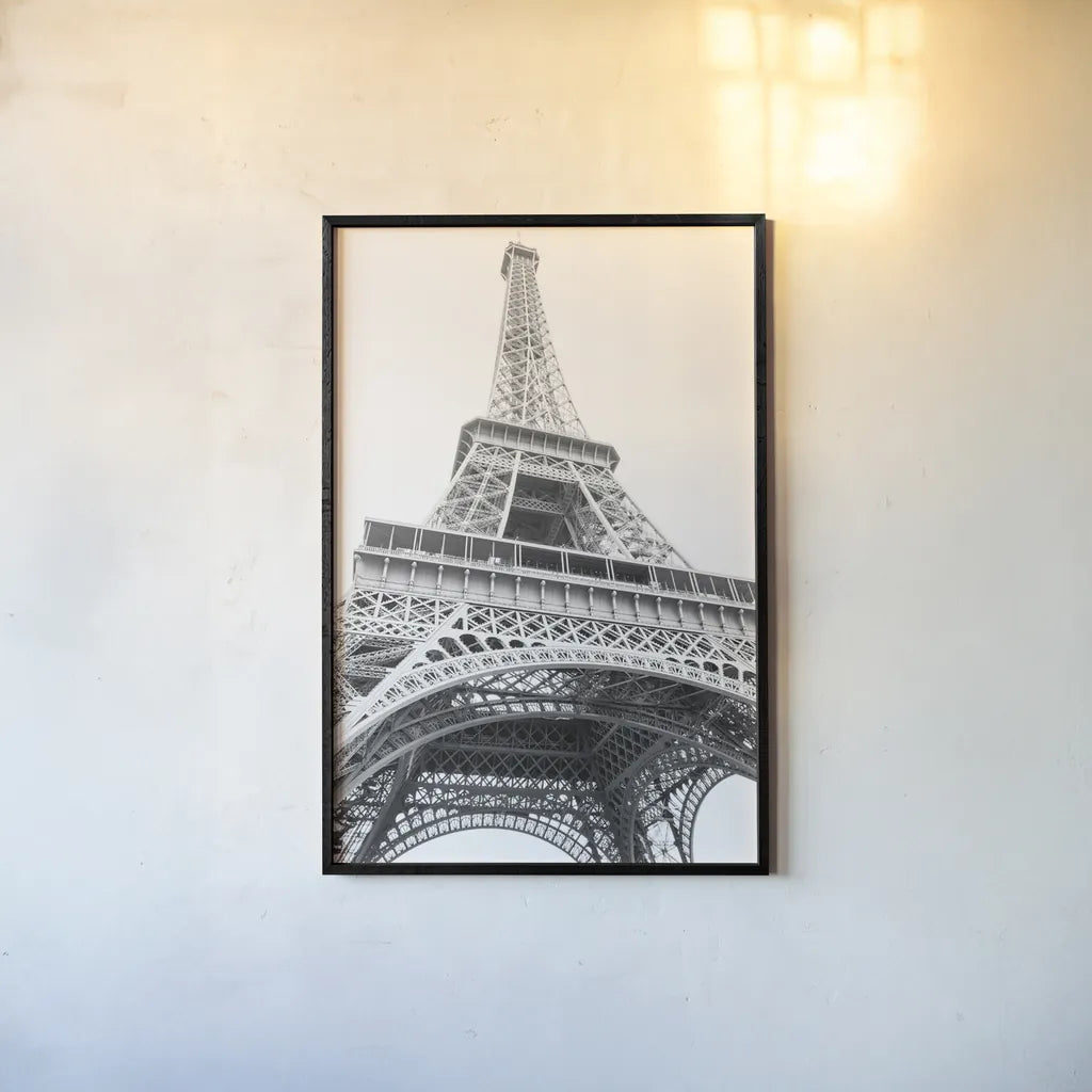Eiffel up Close by Laura Marshall. shown as a paper print in a black flame. Available as a archival giclee rolled canvas, fine art paper, or poster print. SKU 25888h.