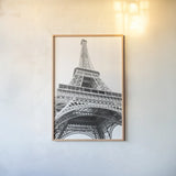 Eiffel up Close by Laura Marshall. shown as a paper print in a natural frame. Available as a archival giclee rolled canvas, fine art paper, or poster print. SKU 25888h.