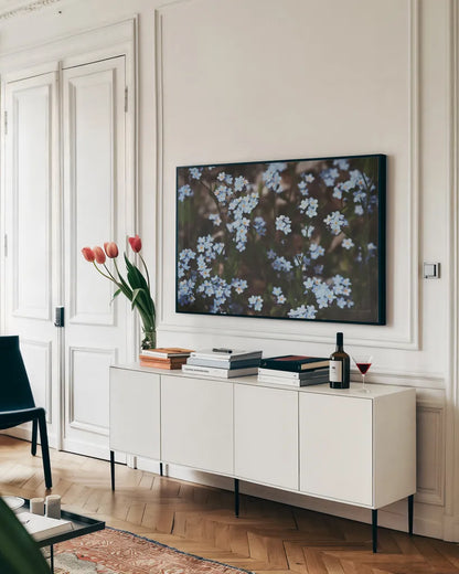 Forget Me Nots II by Laura Marshall. shown as a framed stretched canvas in a living room above a console. Available as a archival giclee rolled canvas, fine art paper, or poster print. SKU 63260i.