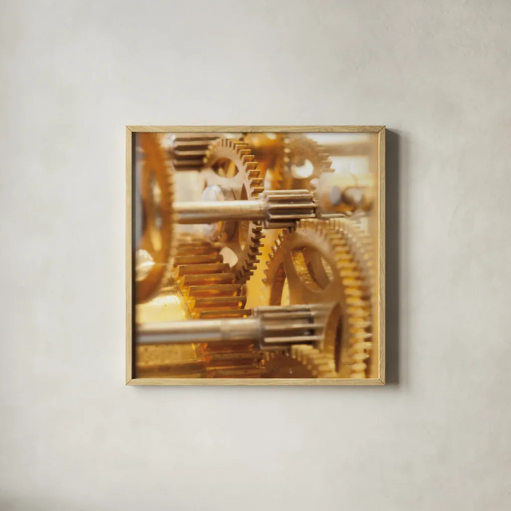 Gilded Gears I by Laura Marshall. Shown in a natural wood glass frame for a timeless modern aesthetic. Available as an archival giclee rolled canvas, fine art paper, or poster print. SKU 25869a.