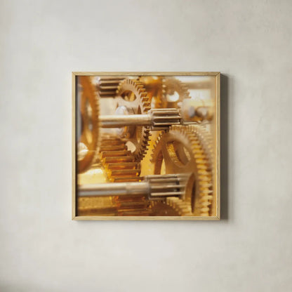 Gilded Gears I by Laura Marshall. Shown in a natural wood glass frame for a timeless modern aesthetic. Available as an archival giclee rolled canvas, fine art paper, or poster print. SKU 25869a.