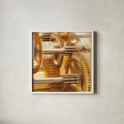 Gilded Gears I by Laura Marshall. Shown in a crisp white glass frame for a clean and minimalist style. Available as an archival giclee rolled canvas, fine art paper, or poster print. SKU 25869a.