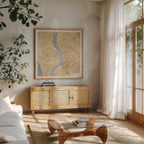 Gilded New York Map by Laura Marshall. Shown in a natural wood frame in a cozy modern living room. Available as an archival giclee rolled canvas, fine art paper, or poster print. SKU 17662a.