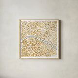Gilded Paris Map by Laura Marshall. Shown in a natural wood glass frame for a timeless modern aesthetic. Available as an archival giclee rolled canvas, fine art paper, or poster print. SKU 17663a.