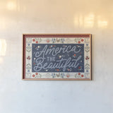 Homespun Americana I v2 by Laura Marshall. shown as a paper print in a natural frame. Available as a archival giclee rolled canvas, fine art paper, or poster print. SKU 104921i.