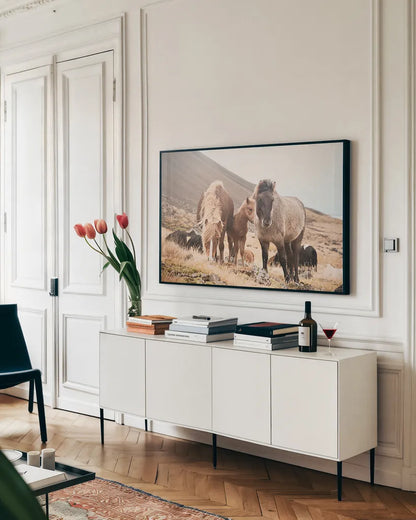 Horses of Hofn I by Laura Marshall. shown as a framed stretched canvas in a living room above a console. Available as a archival giclee rolled canvas, fine art paper, or poster print. SKU 49810i.