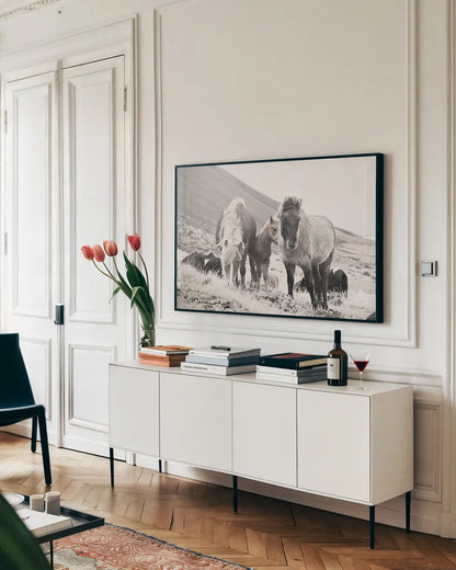 Horses of Hofn I BW by Laura Marshall. shown as a framed stretched canvas in a living room above a console. Available as a archival giclee rolled canvas, fine art paper, or poster print. SKU 49811i.
