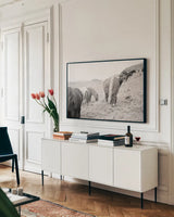 Horses of Hofn II BW by Laura Marshall. shown as a framed stretched canvas in a living room above a console. Available as a archival giclee rolled canvas, fine art paper, or poster print. SKU 49813i.
