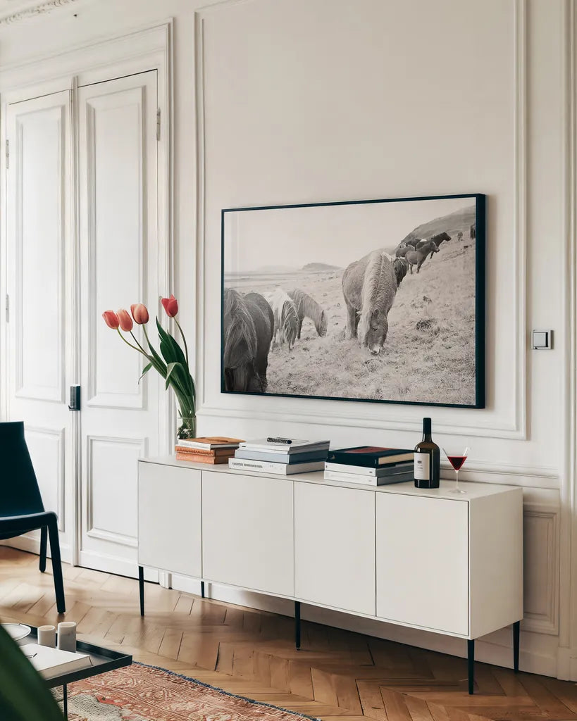 Horses of Hofn II BW by Laura Marshall. shown as a framed stretched canvas in a living room above a console. Available as a archival giclee rolled canvas, fine art paper, or poster print. SKU 49813i.