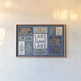 Lakeside Days VI Blue by Laura Marshall. shown as a paper print in a natural frame. Available as a archival giclee rolled canvas, fine art paper, or poster print. SKU 84700i.