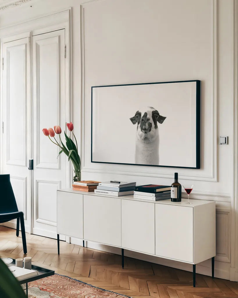 Lovable Llama II by Laura Marshall. shown as a framed stretched canvas in a living room above a console. Available as a archival giclee rolled canvas, fine art paper, or poster print. SKU 28489i.