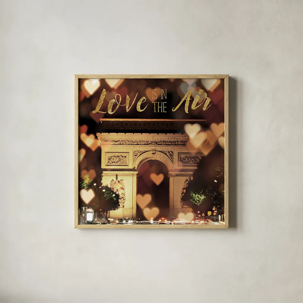 Love is in the Air Arc de Triomphe by Laura Marshall. Shown in a natural wood glass frame for a timeless modern aesthetic. Available as an archival giclee rolled canvas, fine art paper, or poster print. SKU 32258a.