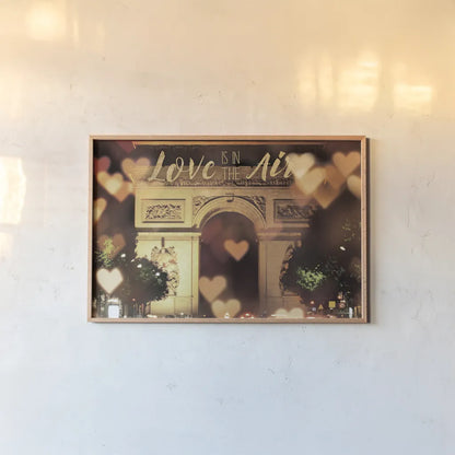 Love is in the Arc de Triomphe v2 by Laura Marshall. shown as a paper print in a natural frame. Available as a archival giclee rolled canvas, fine art paper, or poster print. SKU 36980i.