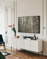 Mossy Pines by Laura Marshall. shown as a framed stretched canvas in a living room above a console. Available as a archival giclee rolled canvas, fine art paper, or poster print. SKU 53676i.