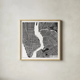 New York Map Black by Laura Marshall. Shown in a natural wood glass frame for a timeless modern aesthetic. Available as an archival giclee rolled canvas, fine art paper, or poster print. SKU 60390a.
