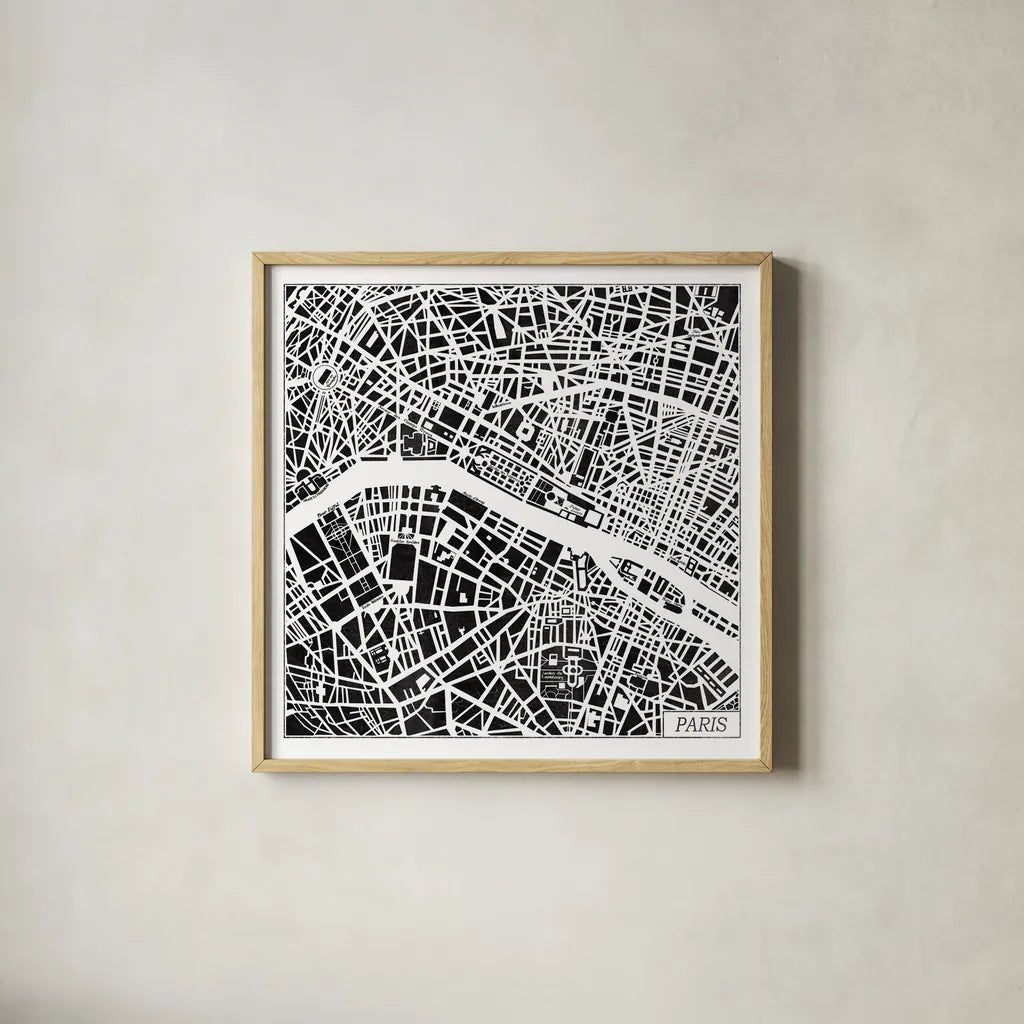 Paris Map Black by Laura Marshall. Shown in a natural wood glass frame for a timeless modern aesthetic. Available as an archival giclee rolled canvas, fine art paper, or poster print. SKU 60391a.