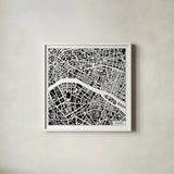 Paris Map Black by Laura Marshall. Shown in a crisp white glass frame for a clean and minimalist style. Available as an archival giclee rolled canvas, fine art paper, or poster print. SKU 60391a.