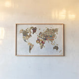 Pattern World Map by Laura Marshall. shown as a paper print in a natural frame. Available as a archival giclee rolled canvas, fine art paper, or poster print. SKU 22904i.