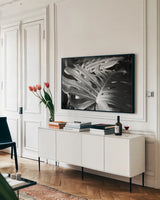 Philodendron by Laura Marshall. shown as a framed stretched canvas in a living room above a console. Available as a archival giclee rolled canvas, fine art paper, or poster print. SKU 48182i.