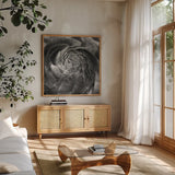 Ranunculus Abstract II BW by Laura Marshall. Shown in a natural wood frame in a cozy modern living room. Available as an archival giclee rolled canvas, fine art paper, or poster print. SKU 25285a.