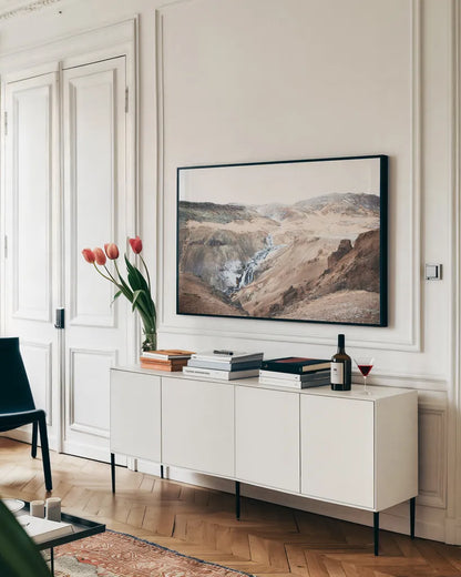 Reykjadalur Hot River by Laura Marshall. shown as a framed stretched canvas in a living room above a console. Available as a archival giclee rolled canvas, fine art paper, or poster print. SKU 69905i.
