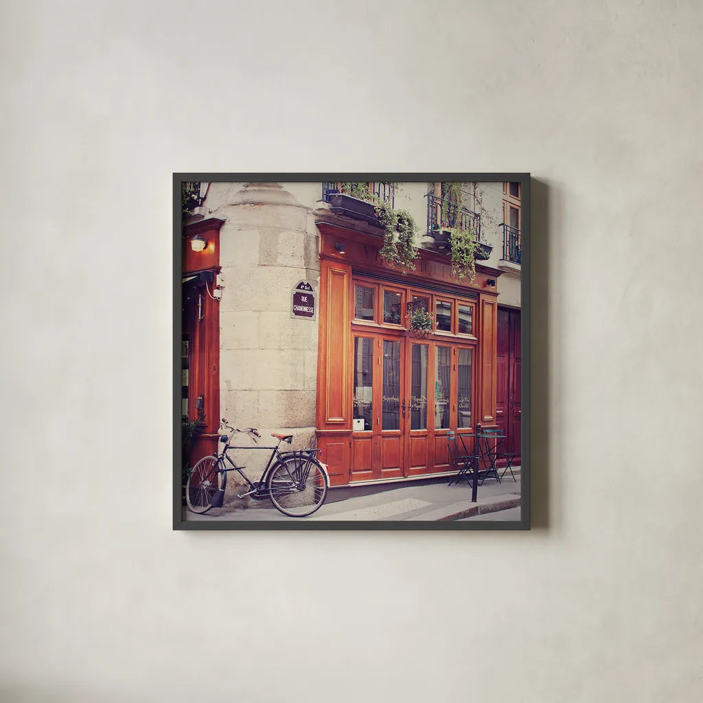 Rue Chanoinesse by Laura Marshall. Shown in a sleek black glass frame for a contemporary gallery look. Available as an archival giclee rolled canvas, fine art paper, or poster print. SKU 21920a.