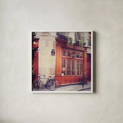 Rue Chanoinesse by Laura Marshall. Shown in a crisp white glass frame for a clean and minimalist style. Available as an archival giclee rolled canvas, fine art paper, or poster print. SKU 21920a.