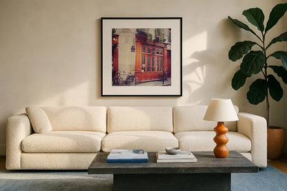 Rue Chanoinesse by Laura Marshall. Displayed in a glass frame with matte in a clean modern living room. Available as an archival giclee rolled canvas, fine art paper, or poster print. SKU 21920a.