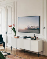 Santa Monica Pier by Laura Marshall. shown as a framed stretched canvas in a living room above a console. Available as a archival giclee rolled canvas, fine art paper, or poster print. SKU 81306i.