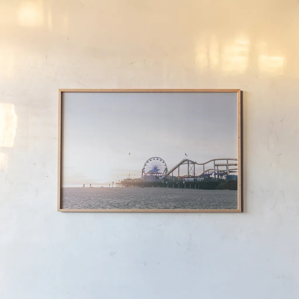 Santa Monica Pier by Laura Marshall. shown as a paper print in a natural frame. Available as a archival giclee rolled canvas, fine art paper, or poster print. SKU 81306i.