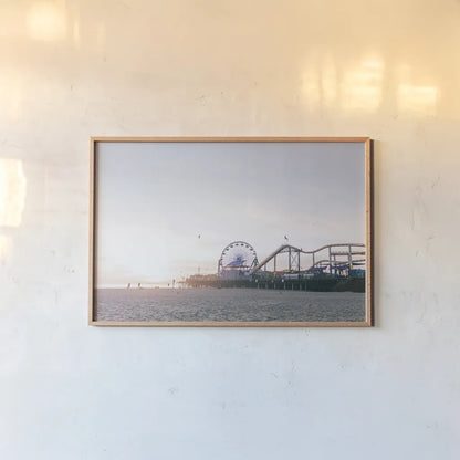 Santa Monica Pier by Laura Marshall. shown as a paper print in a natural frame. Available as a archival giclee rolled canvas, fine art paper, or poster print. SKU 81306i.