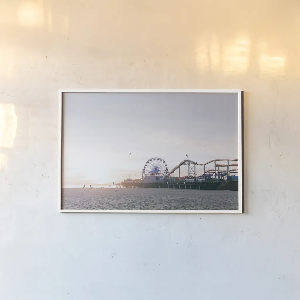 Santa Monica Pier by Laura Marshall. shown as a paper print in a white frame. Available as a archival giclee rolled canvas, fine art paper, or poster print. SKU 81306i.
