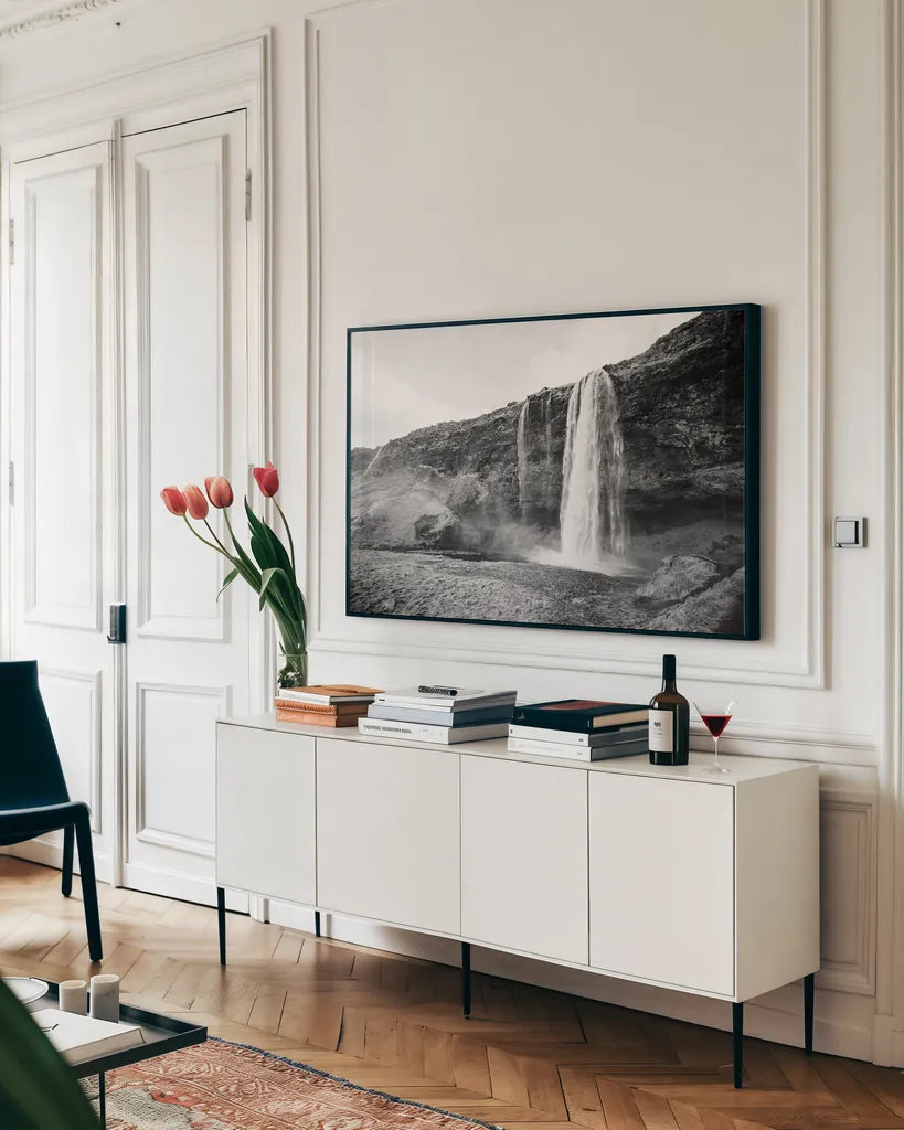 Seljalandsfoss by Laura Marshall. shown as a framed stretched canvas in a living room above a console. Available as a archival giclee rolled canvas, fine art paper, or poster print. SKU 64395i.