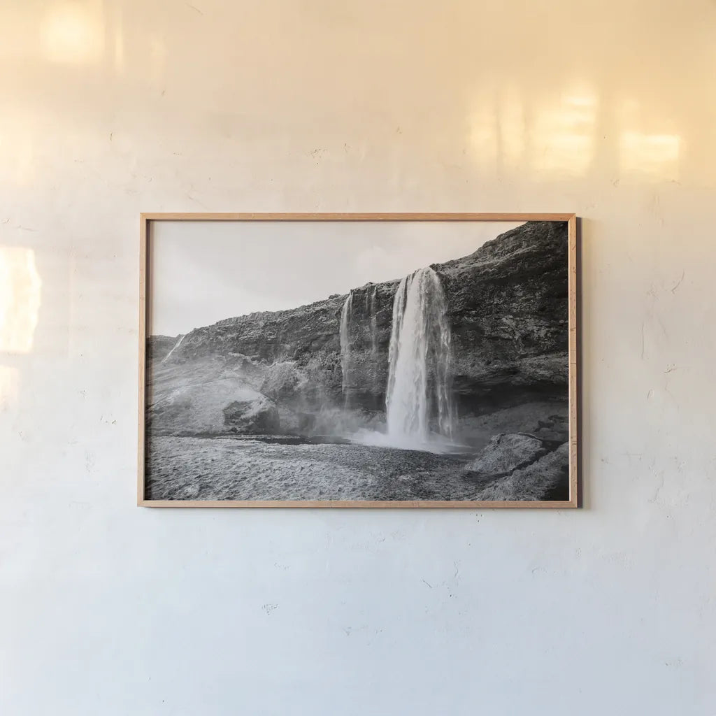 Seljalandsfoss by Laura Marshall. shown as a paper print in a natural frame. Available as a archival giclee rolled canvas, fine art paper, or poster print. SKU 64395i.