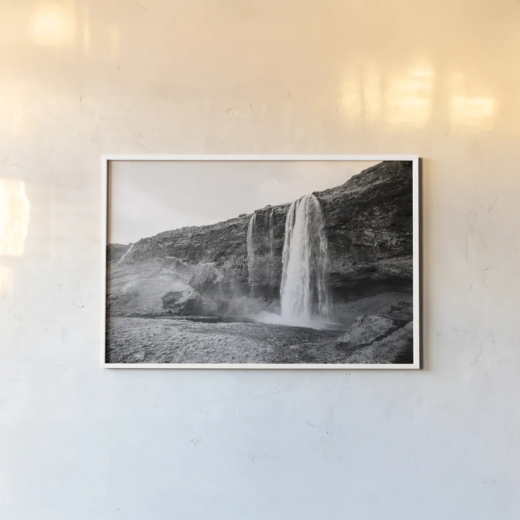 Seljalandsfoss by Laura Marshall. shown as a paper print in a white frame. Available as a archival giclee rolled canvas, fine art paper, or poster print. SKU 64395i.