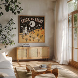 Spooky Village III by Laura Marshall. Shown in a natural wood frame in a cozy modern living room. Available as an archival giclee rolled canvas, fine art paper, or poster print. SKU 48106a.