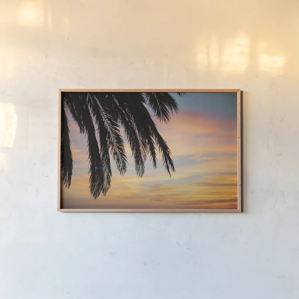 Sunset Palms I by Laura Marshall. shown as a paper print in a natural frame. Available as a archival giclee rolled canvas, fine art paper, or poster print. SKU 42851i.