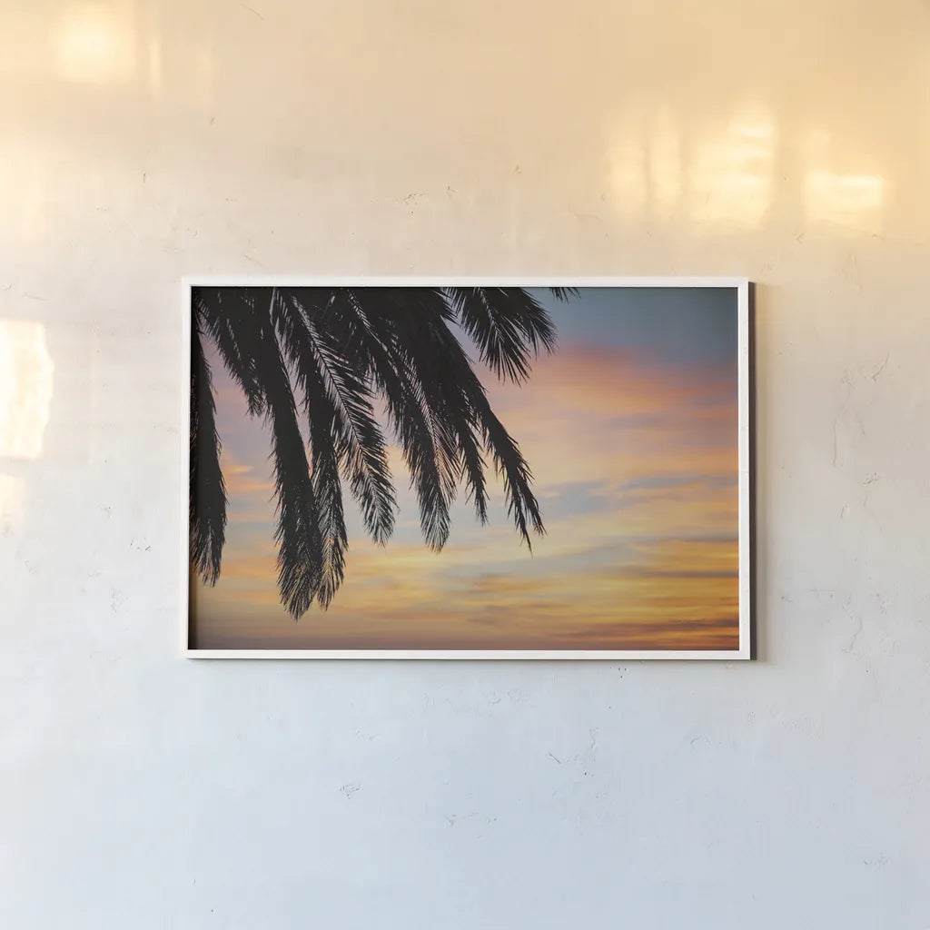 Sunset Palms I by Laura Marshall. shown as a paper print in a white frame. Available as a archival giclee rolled canvas, fine art paper, or poster print. SKU 42851i.